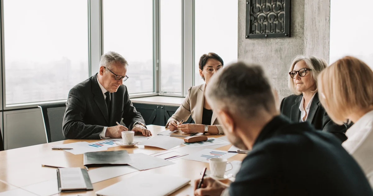 Senior public-sector leaders reviewing fiscal transparency and oversight documents