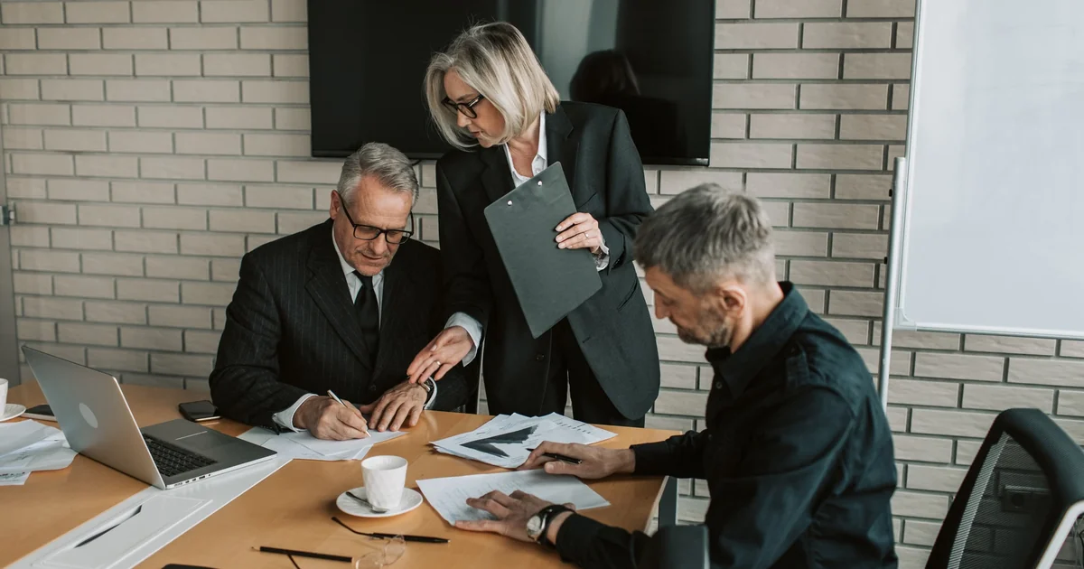 Senior analysts reviewing government finance statistics in a conference room