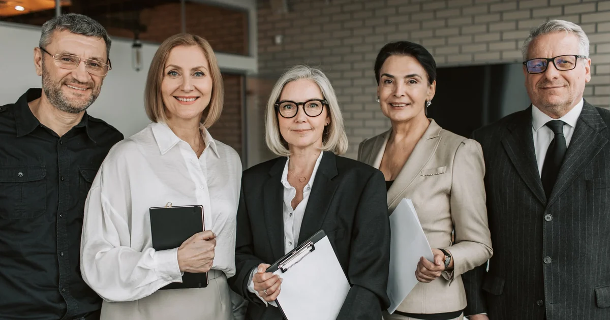 Senior finance professionals reviewing government financial reports