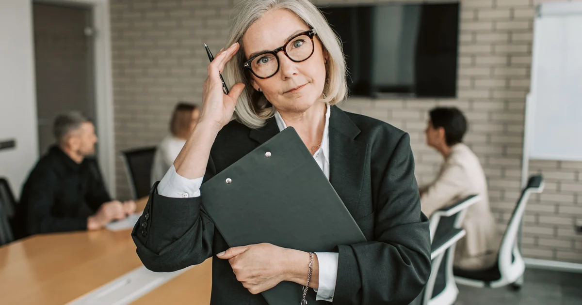 Senior auditors reviewing internal controls and government documents