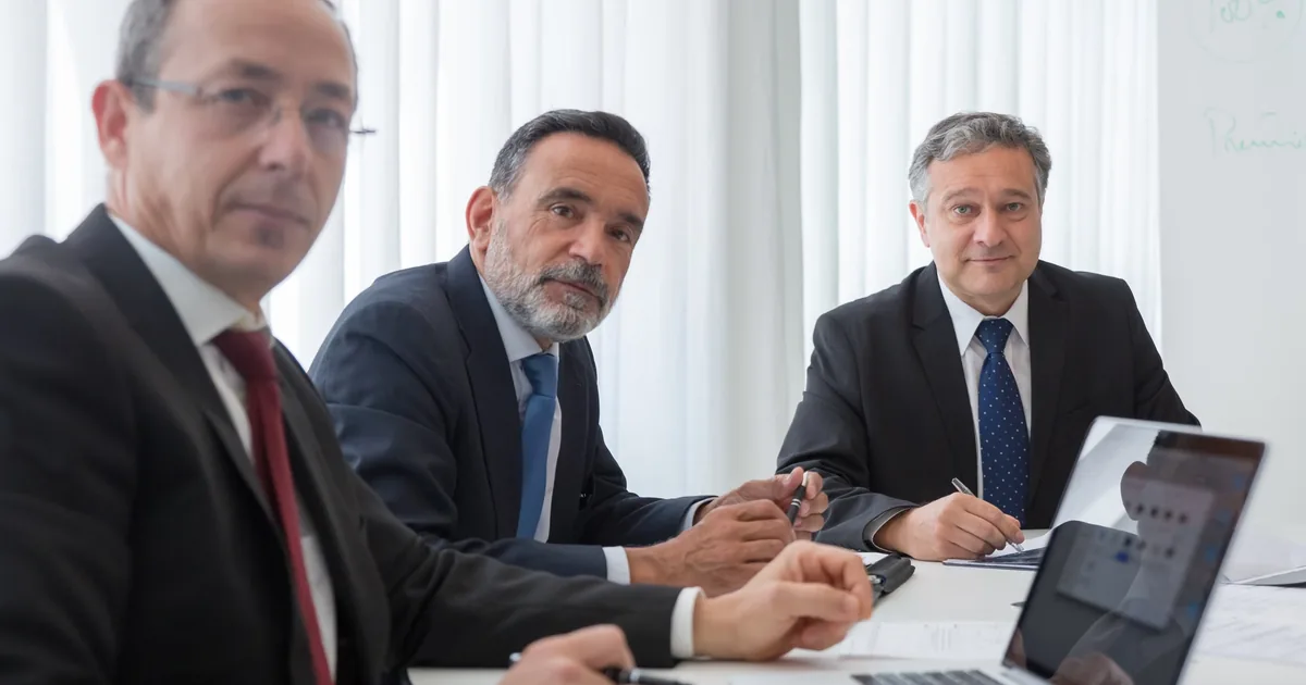 Senior public finance executives attending a formal boardroom workshop